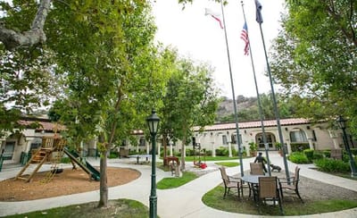 Outdoor courtyard with benches and playground equipment