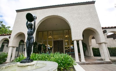 Exterior view of the facility with a fountain