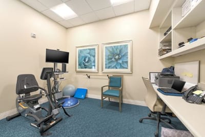 Well-equipped fitness room with exercise equipment and decor