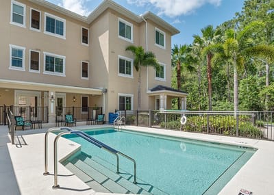 Pool area with seating and landscaping at Somerby Lake Nona