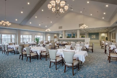 Dining area with elegantly set tables and chairs