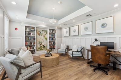 Comfortable interior common area with bookshelves and seating