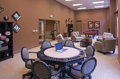 Well-lit common area with seating and a pool table