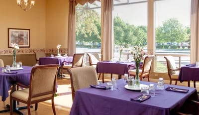 Bright dining area with purple table settings