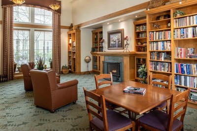 A cozy common area with bookshelves and seating