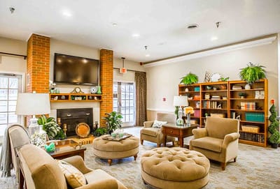 Bright common area with seating and a fireplace