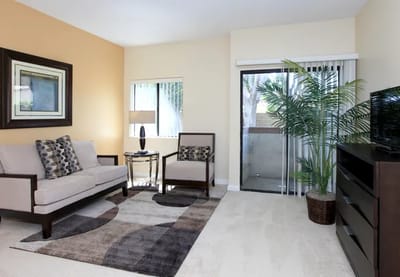 A bright, furnished living room in a senior care facility