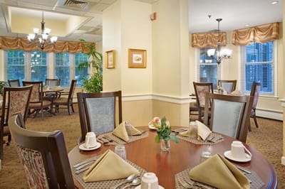 Dining room setup with tables and flowers