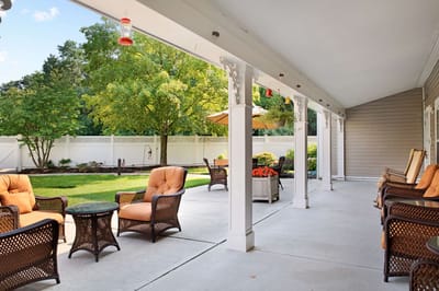 Outdoor patio area with seating and greenery