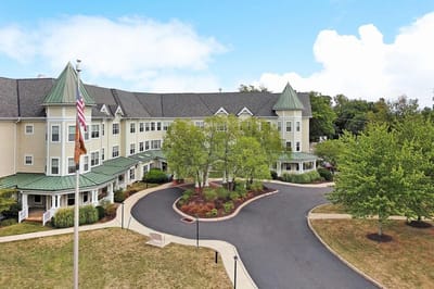 Exterior view of Sunrise of Abington facility showing landscaping and entrance