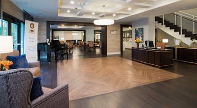 Bright interior common area with seating and piano