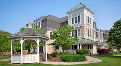 Exterior view of a senior living facility with gazebo