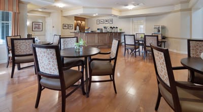 Bright common area with seating and a coffee station