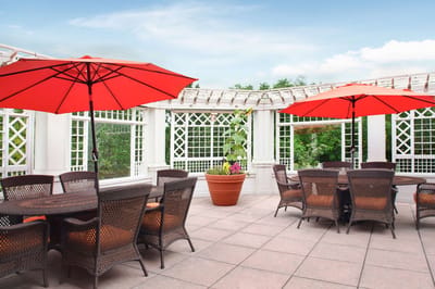 Outdoor social space with red umbrellas and seating