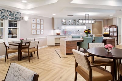 Bright and inviting common area with dining tables and decor