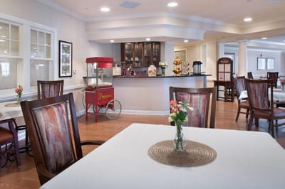 Dining area with tables and popcorn cart