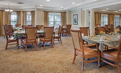 Dining area with tables and chairs set for meals
