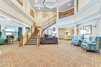 Spacious lobby area with seating and staircase