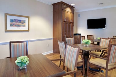 Bright common area with dining tables and chairs