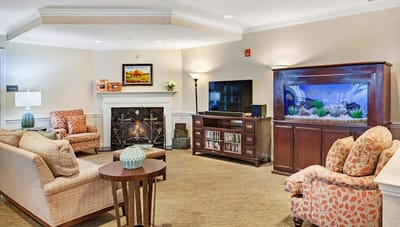 A cozy common area with seating and an aquarium