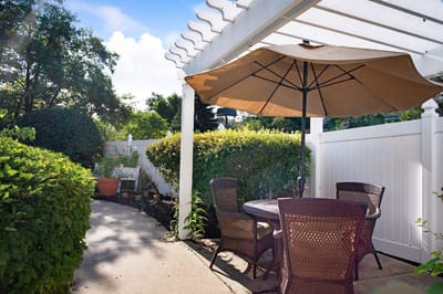 Outdoor seating area with a shaded table and chairs