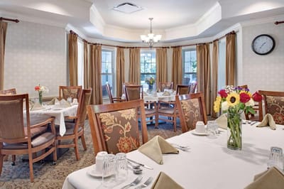 Dining area with elegantly set tables and floral arrangements