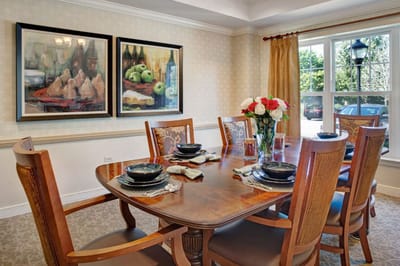 Dining area with a large table and floral centerpiece