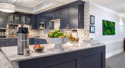 Bright kitchen area with fresh fruit and coffee setup