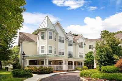 Exterior view of a senior living facility with gardens