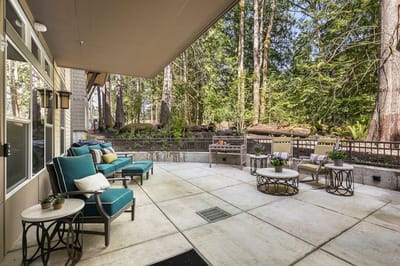 Outdoor patio area with seating and greenery