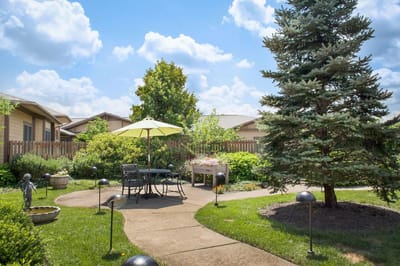 Garden area with seating and umbrella on a sunny day