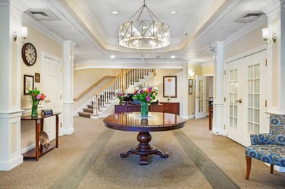 Bright lobby area with floral arrangements and staircase