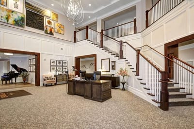 Bright and inviting lobby with stairway and seating areas