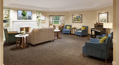 Bright and inviting common area with seating and piano