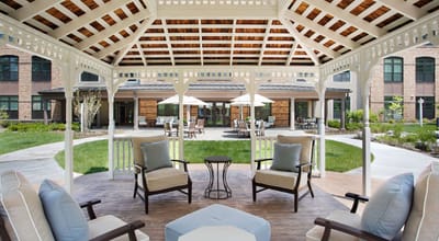 Covered seating area in a landscaped courtyard
