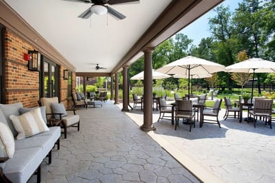 Covered outdoor seating area with umbrellas and garden view