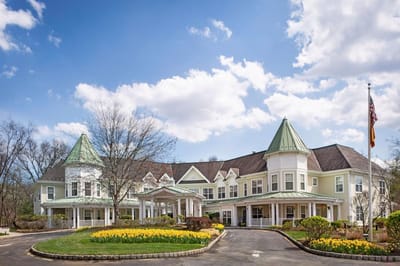 Exterior view of Sunrise of Old Tappan facility with landscaped entrance