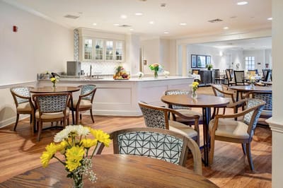 Bright dining area with tables and flowers
