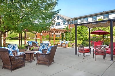 Outdoor seating area with patio furniture and greenery
