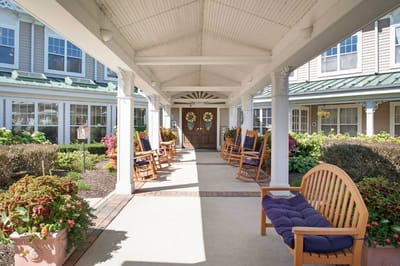 Outdoor seating area with rocking chairs and plants