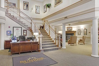 Bright lobby area of a senior living facility with staircase