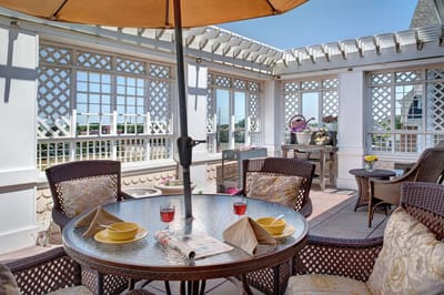 Outdoor patio area with table and umbrella
