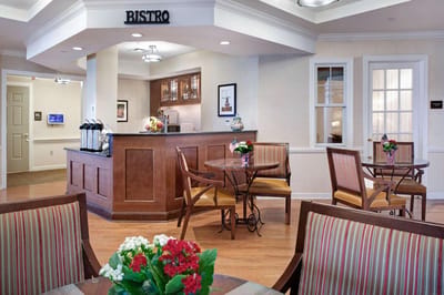 Bright dining area with Bistro sign and tables