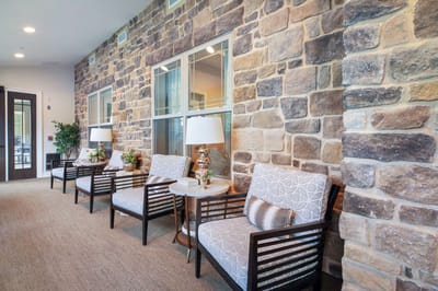 Cozy lounge area with stone walls and armchairs