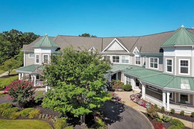 Aerial view of a senior living facility entrance with landscaping