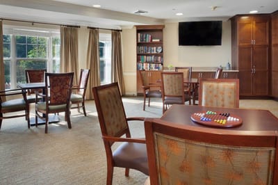 Bright common area with tables and bookshelves