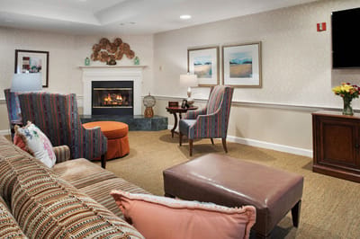 Bright lounge area with comfortable seating and a fireplace