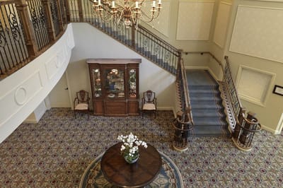 Interior view of a welcoming lobby space with staircase