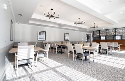 Bright dining room with modern furniture and large windows