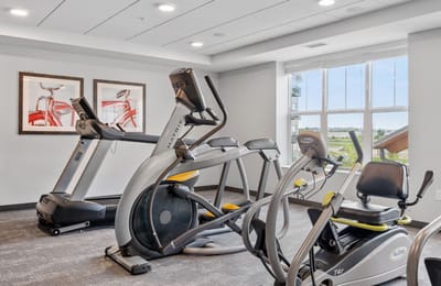 A modern gym with exercise equipment for residents